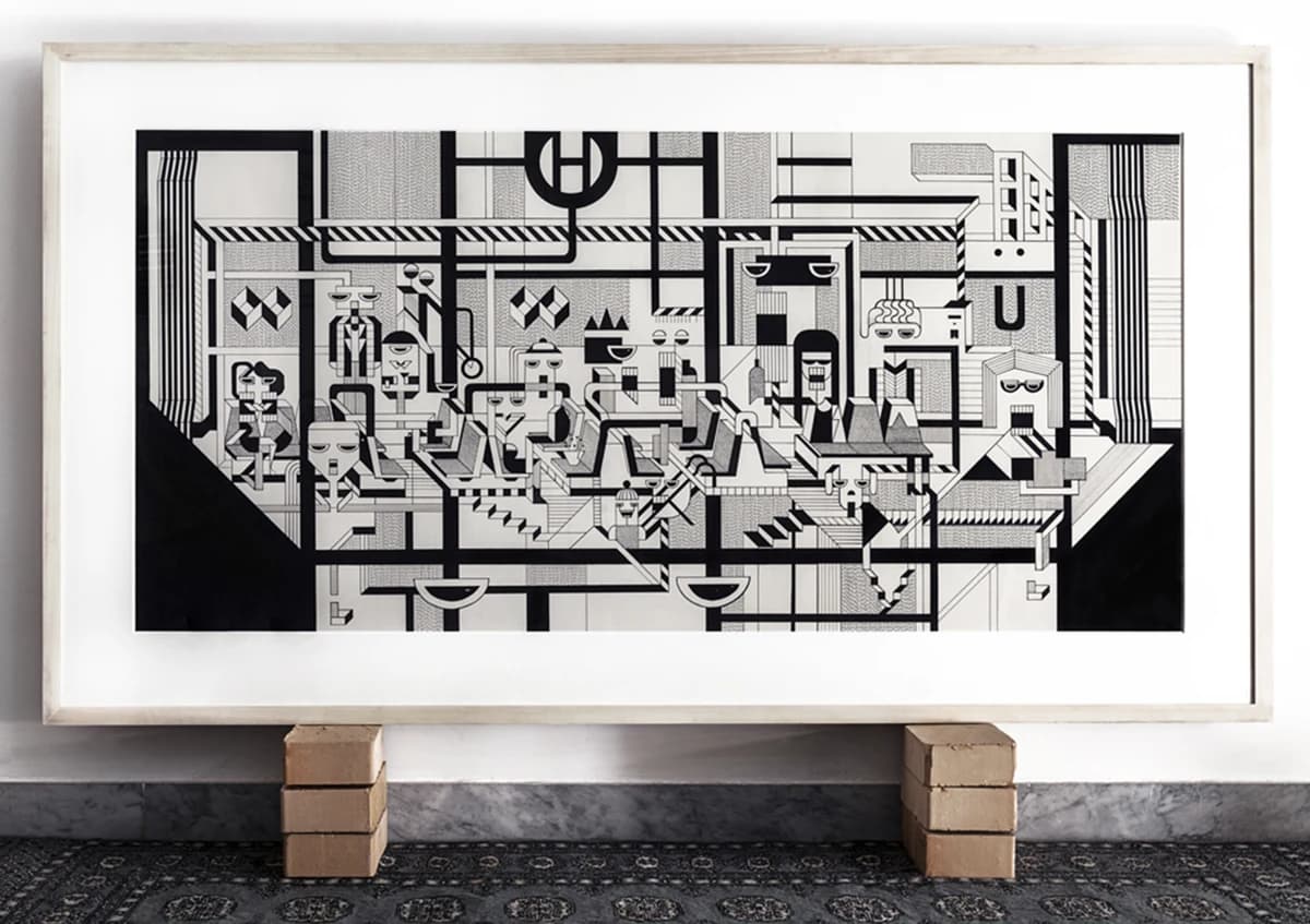 Framed U Berlin ink drawing from the BAI series, displayed on brick supports above a patterned rug.