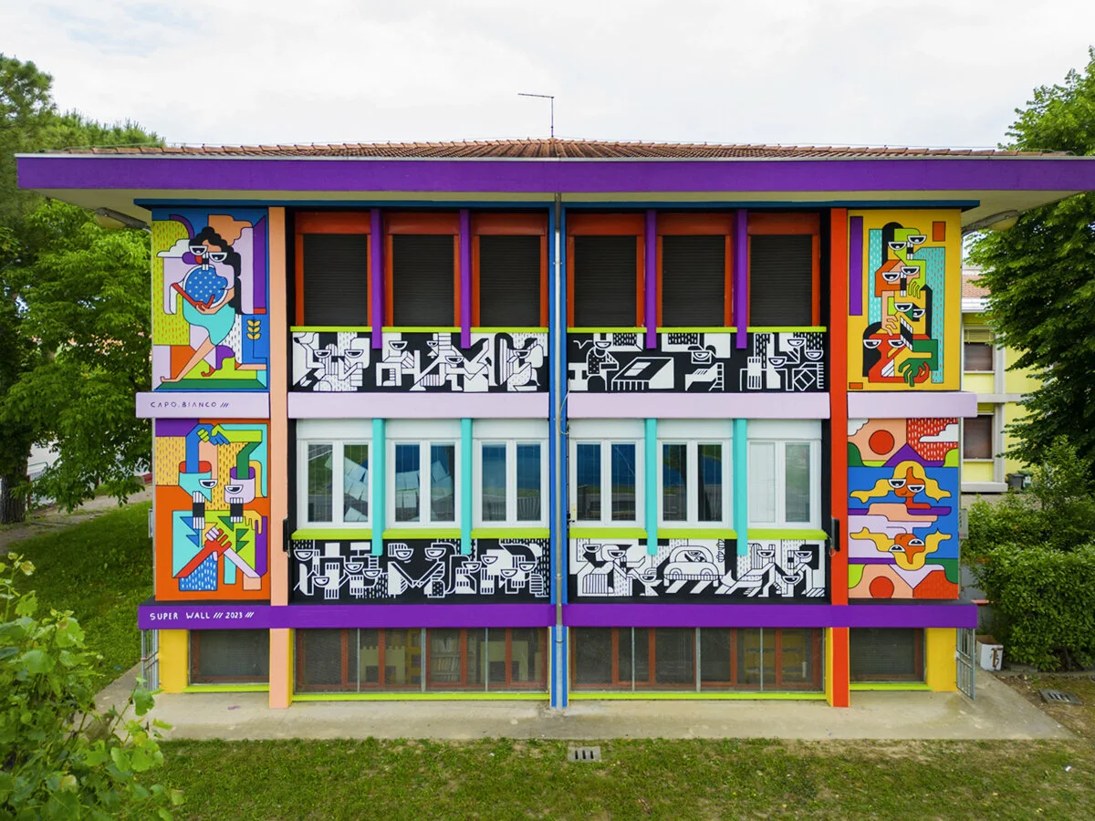 The Respect mural across the colourful façade of Beato Arnaldo secondary school.