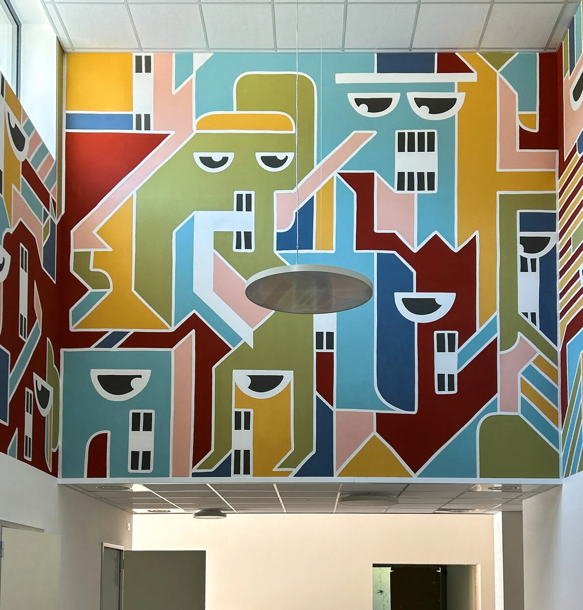 The colourful Un Futuro a Colori mural covering the exterior of Il Tulipano nursery school.